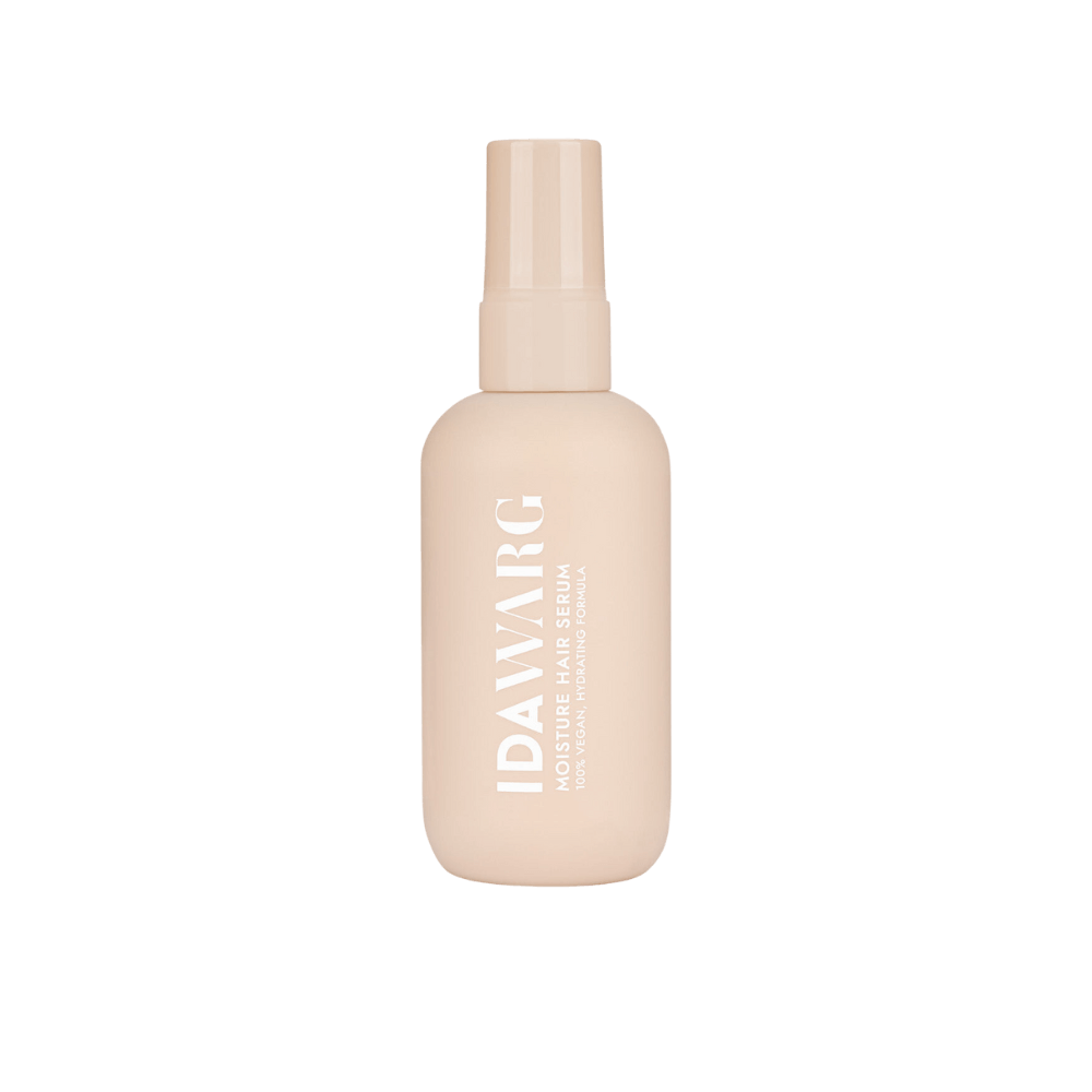 En beige flaska med Moisture Hair Serum från IDA WARG. Flaskan har vit text som beskriver produkten som '100% Vegan Hydrating Formula'.