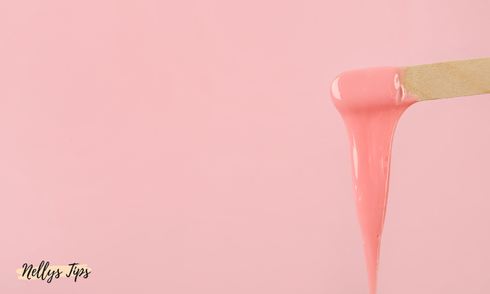 Spatel med rosa varmvattenvax redo att appliceras för smidig hårborttagning