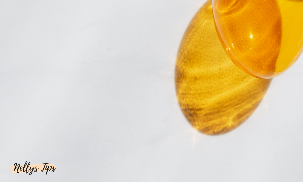 Närbild på gul vätska i kapsel som speglas med ljusreflektioner från solen